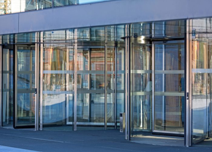 automatic-revolving-doors-at-modern-building-entra-2025-10-06-20-18-35-utc