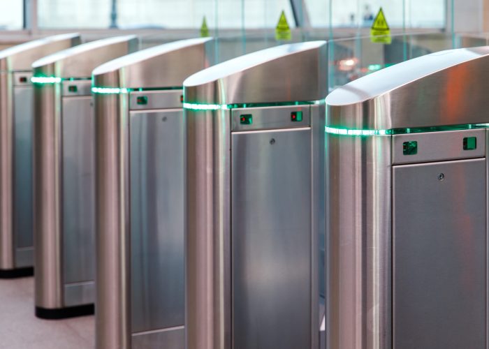 Close up of modern turnstiles for the passage of subway trains transport/ railway station, inside. Entrance in metro with electronic card access.