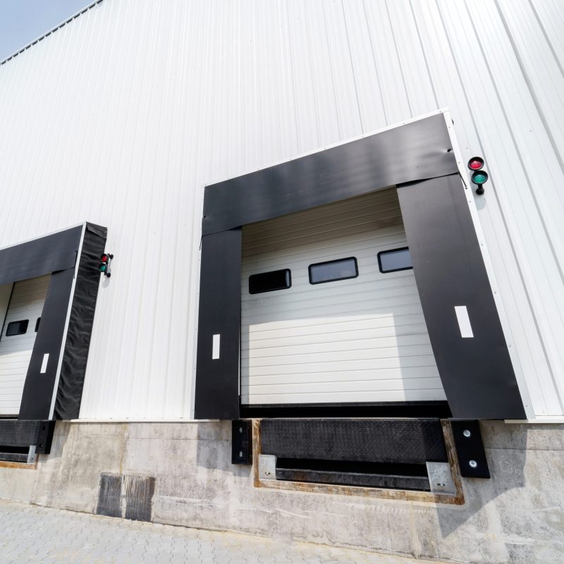 Sectional warehouse gate for loading and unloading cargo in a distributed center. Loading and unloading areas for trucks. Construction of an industrial building